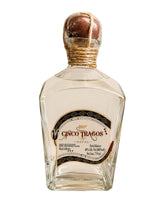 Licomar, Vinos y Licores Sotol Cinco Tragos Blanco 750ml bottle. Clear spirit with a rustic rope-tied wooden stopper.